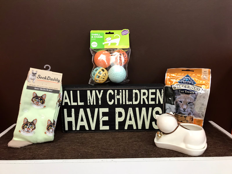 9. "All my children have paws" sign, cat socks, ceramic cat planter, Blue Wilderness treats, ball toys